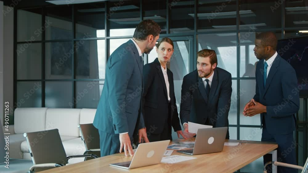 Corporate business team in a meeting. Group of young people in suits in the office Corporate business team in a meeting. Group of young people in suits in the office