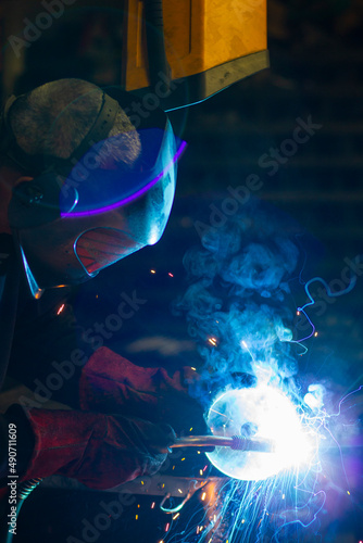 man in workshop working with metal and welding © PAU