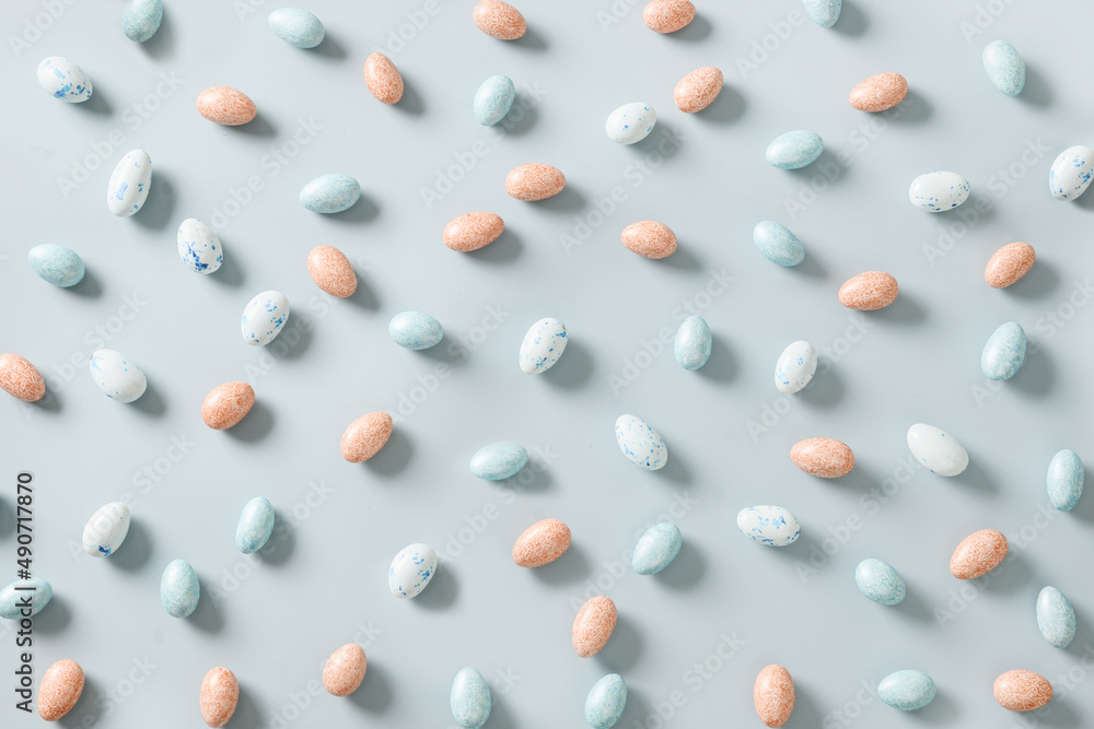 Easter pattern with pastel chocolate eggs on blue background. Religion tradition. View from above. Flat lay style. Easter pattern with pastel chocolate eggs on blue background. Religion tradition. View from above. Flat lay style.