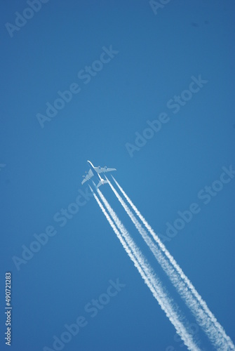 Brtish airways airbus A380, high flying four-engine passenger plane, aircraft, clear bleu sky, contrails 