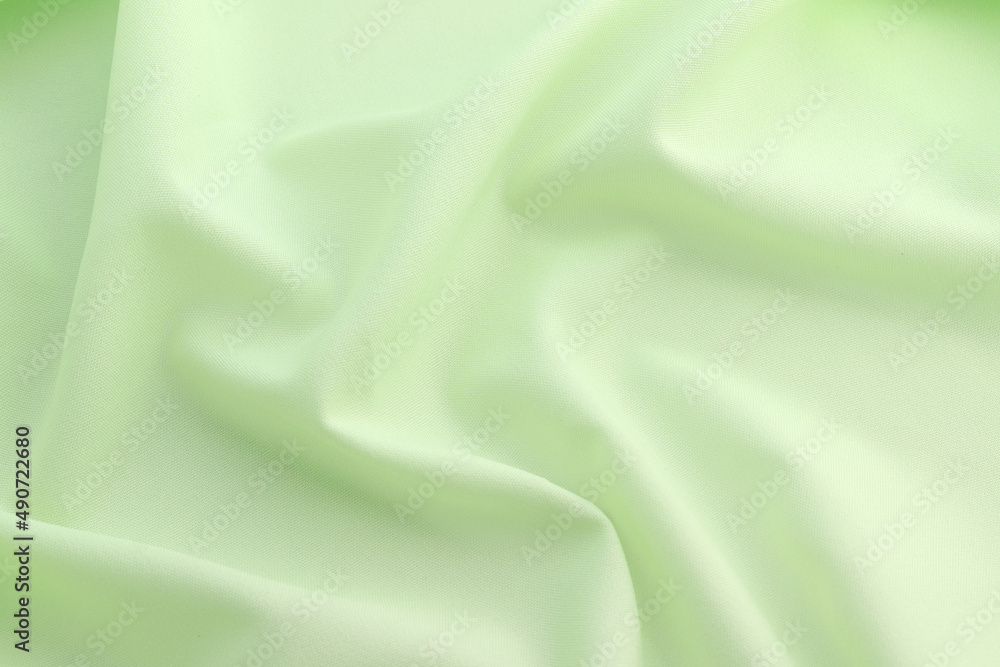 Fototapeta premium Smooth elegant green satin silk background. Copy space for text anniversary christmas background