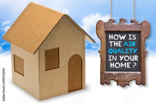 HOW IS THE AIR QUALITY IN YOUR HOME? - concept with home icon, wooden sign and text photo