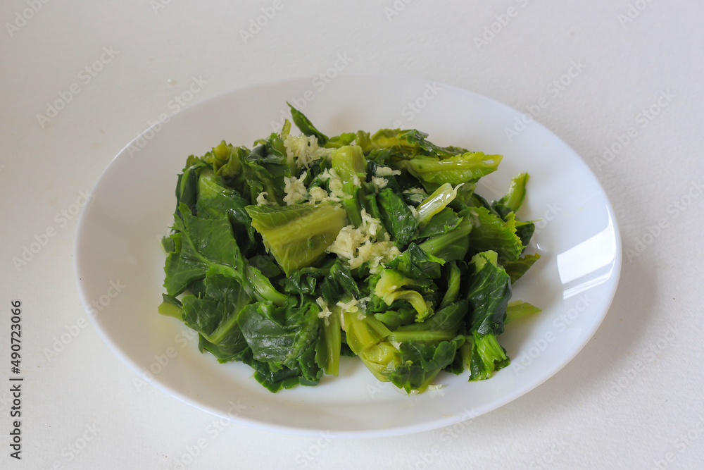 Freshly harvested cibes grass on a white background . A type of cabbage sprout used for cooking in Turkish cuisine . Freshly harvested cibes grass on a white background . A type of cabbage sprout used for cooking in Turkish cuisine .