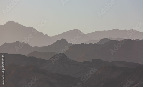Fototapeta Naklejka Na Ścianę i Meble -  Dramatic layered mountains of Sinai in the evening. View from Dahab. South Sinai, Egypt