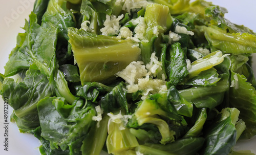 Freshly harvested cibes grass on a white background . A type of cabbage sprout used for cooking in Turkish cuisine . photo