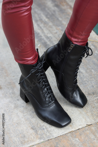 Amaze low lace up square toe block heel ankle black leather boots. top view. red leggings
