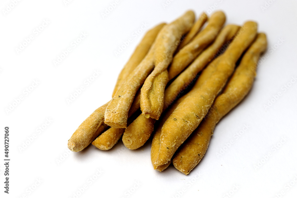 Heap of Italian breadsticks grissini on a white background - started in Italian cuisine Heap of Italian breadsticks grissini on a white background - started in Italian cuisine