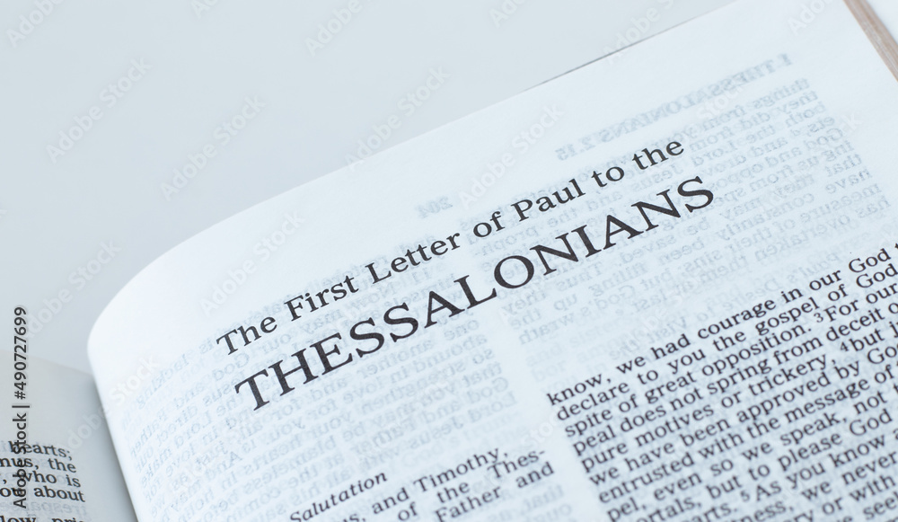 Thessalonians open Holy Bible Book close-up. New Testament Scripture. Studying the Word of God Jesus Christ. Christian biblical concept of faith and trust. Thessalonians open Holy Bible Book close-up. New Testament Scripture. Studying the Word of God Jesus Christ. Christian biblical concept of faith and trust.