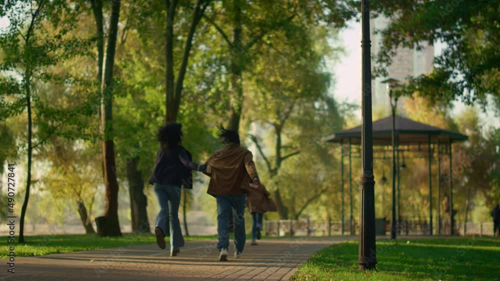 Family resting autumn park running path together rear view. Happy leisure time. Family resting autumn park running path together rear view. Happy leisure time.
