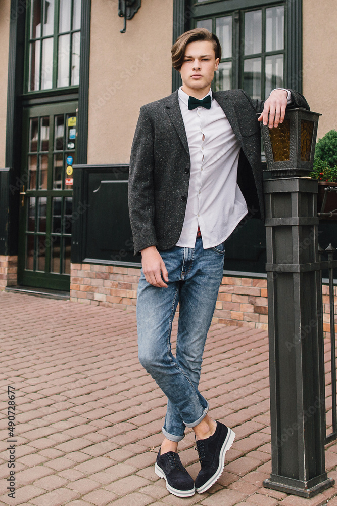 Attractive young man on the street on a background of pencil background. Attractive young man on the street on a background of pencil background.