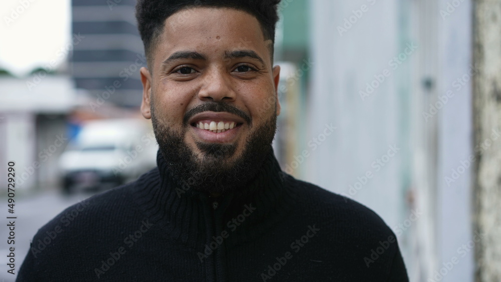 A friendly young man walking forward to camera in urban street outside A friendly young man walking forward to camera in urban street outside