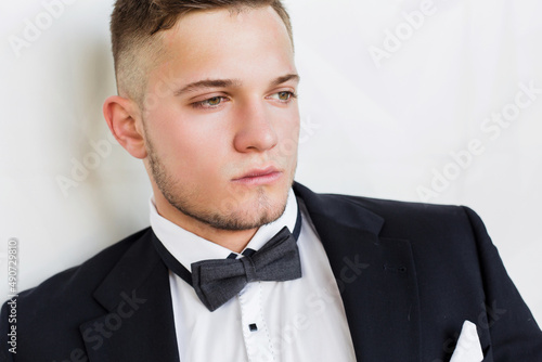 Clever young man, employee, future generation of businessman close up on white background.