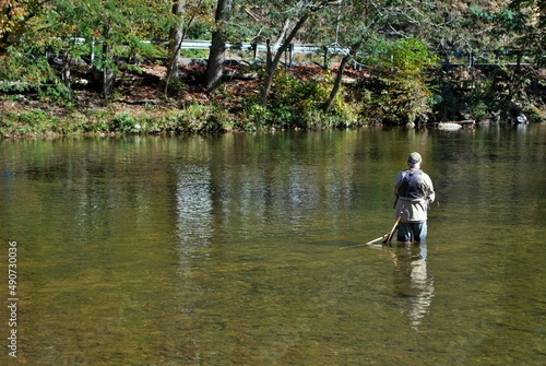 Unrecognizable old man fishing in the little river Gatlinburg Tennessee