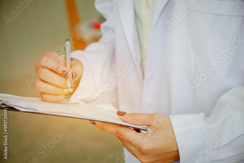 Female doctor is recording important information in the clinic.