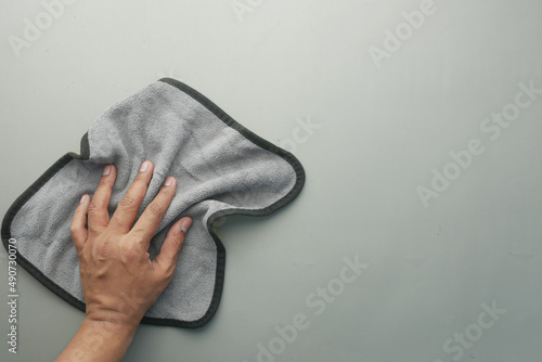 top view of person hand cleaning table with cloth 