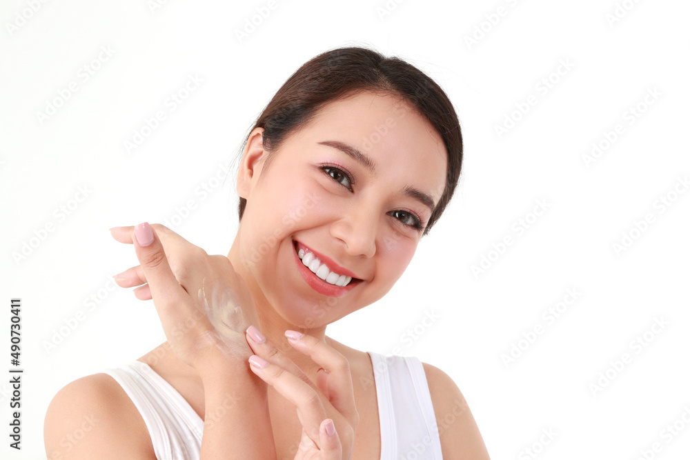 Beautiful Asian woman applying skin cream on her arm to enhance her beauty. She takes care of her skin health to be smooth, bright, healthy, natural. beauty concept health care. White background. Beautiful Asian woman applying skin cream on her arm to enhance her beauty. She takes care of her skin health to be smooth, bright, healthy, natural. beauty concept health care. White background.
