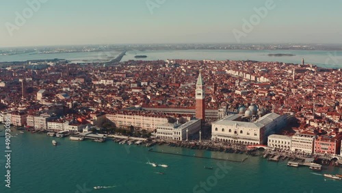 Close up dolly forward drone shot over Venice lagoon towards St Marco Square tower photo