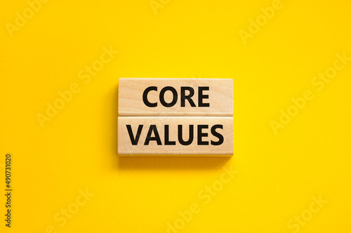 Core values symbol. Concept words Core values on wooden blocks on a beautiful yellow table yellow background. Business value and core values concept, copy space.