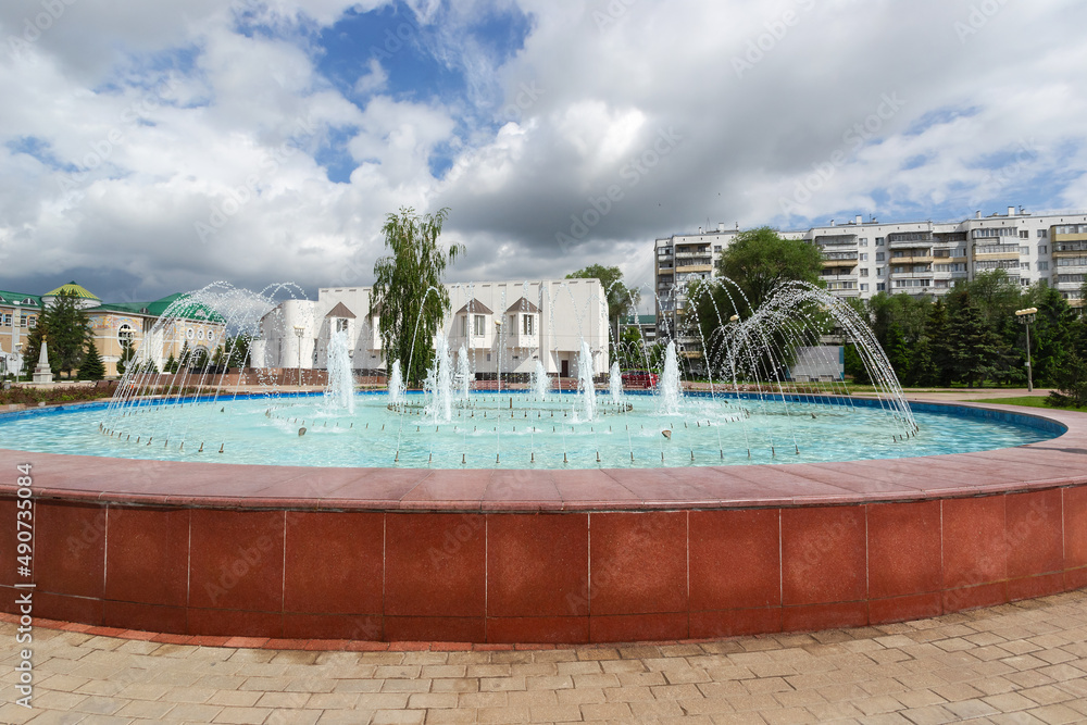Fountain with gushing jets of water in Belgorod on the background of the urban landscape. The concept of travel in Russia
