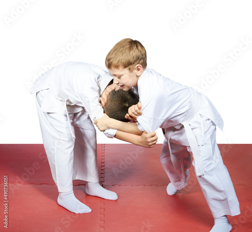 On the mats the children trained judo sparring