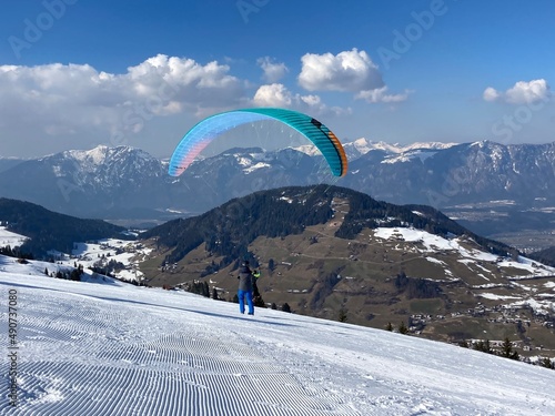 Paraglider with a kite in the alp mountains