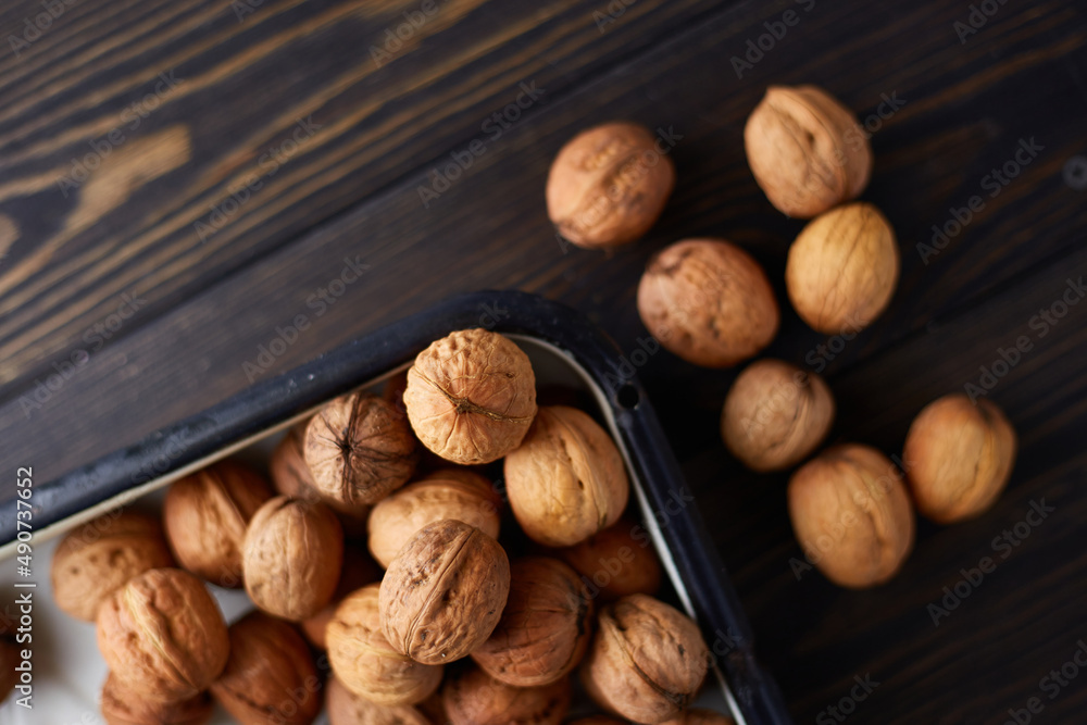 Natural whole walnuts on dark wooden table. Top view, flat lay with copy space Natural whole walnuts on dark wooden table. Top view, flat lay with copy space