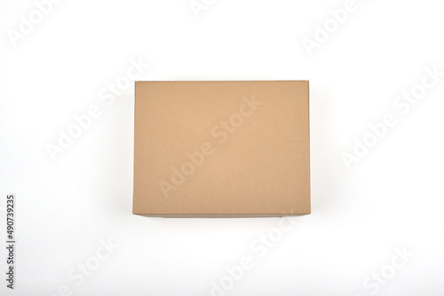 Studio shot of a paper box. Brown box on a white background. Packaging concept. Cardboard box. © sushaaa