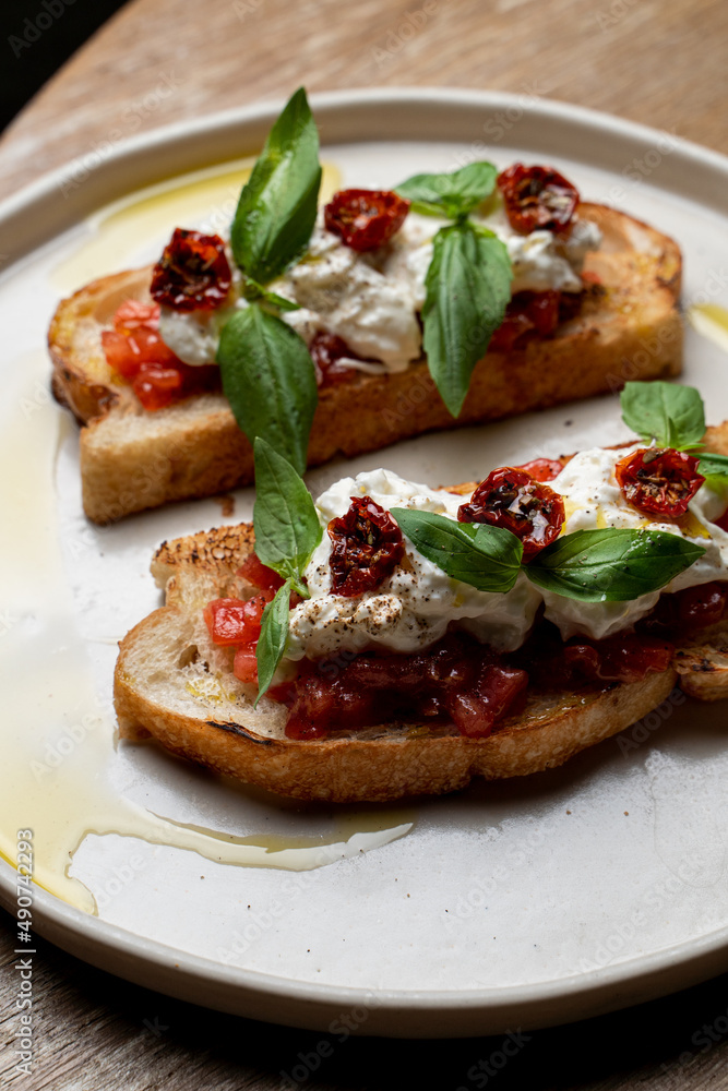 Traditional italian sandwiches with tomatoes and cream cheese, appetising commercial photo, yummy texture is visible Traditional italian sandwiches with tomatoes and cream cheese, appetising commercial photo, yummy texture is visible