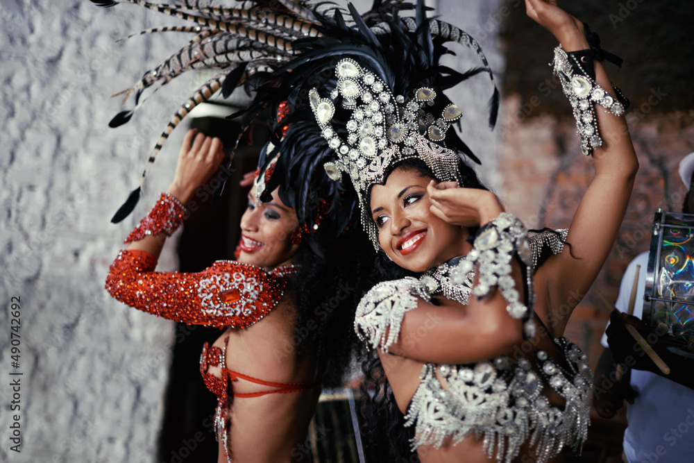 For the joy of samba. Shot of two beautiful samba dancers performing in a carnival. - obrazy, fototapety, plakaty 