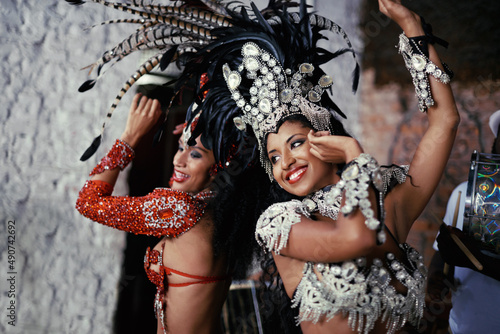 For the joy of samba. Shot of two beautiful samba dancers performing in a carnival.