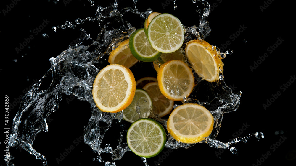 Freeze motion of sliced limes and lemons in water splash. Freeze motion of sliced limes and lemons in water splash.