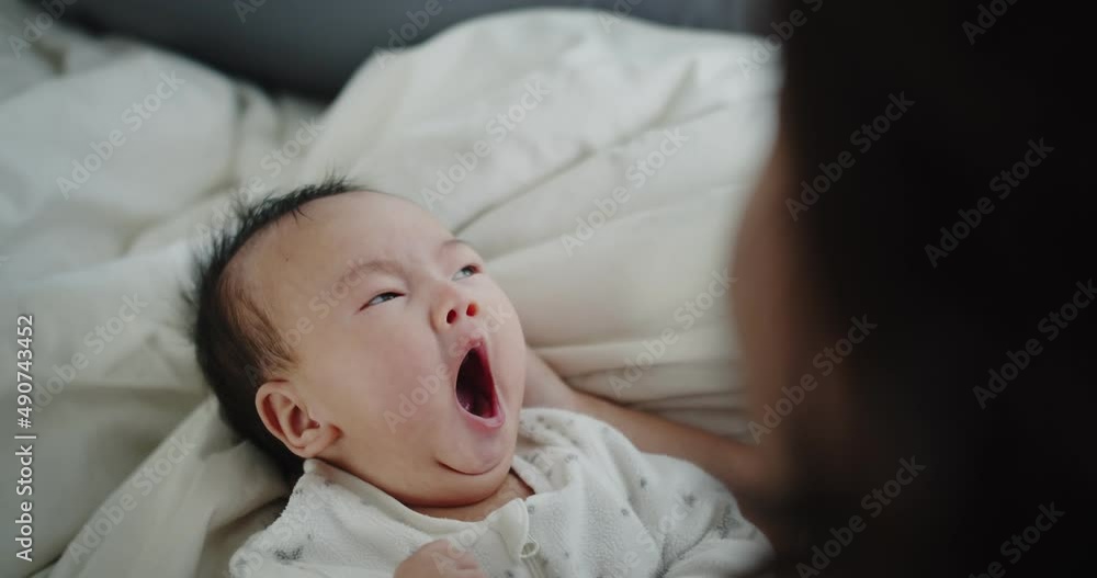 Close up adorable newborn baby infant child girl Yawning on the bed in the morning at home, family, children, parenthood, childhood, life, love concept Close up adorable newborn baby infant child girl Yawning on the bed in the morning at home, family, children, parenthood, childhood, life, love concept