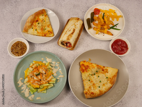 french fries and tomatoes, pizza, vegetable roll and salad