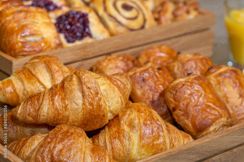 A delicious selection of continental breakfast pastries including croissants, cinnamon swirls and pain au chocolat