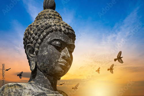 Photography Buddha face, The Buddha statue is made of gold bronze On natural background