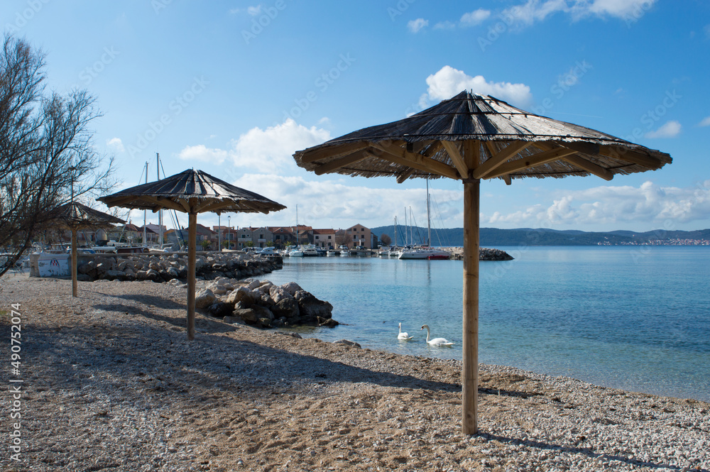Coastal village Bibinje close to Zadar in Croatia, beautiful beach with parasols close to the marina