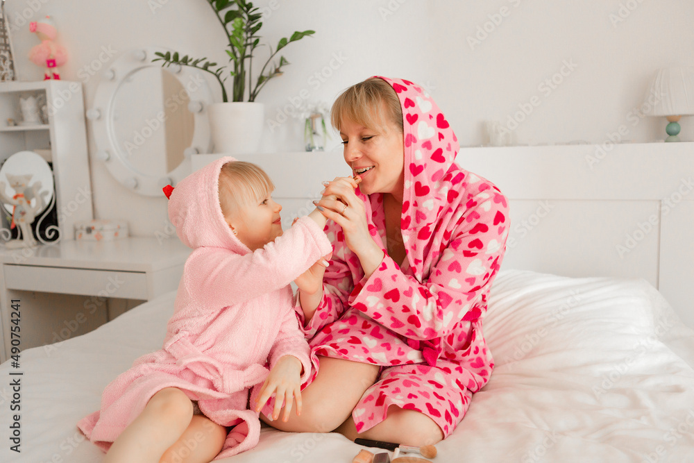 Happy Mother And Little Daughter Play, Make Up Each Other, Have Fun Together At Home. Family weekend Happy Mother And Little Daughter Play, Make Up Each Other, Have Fun Together At Home. Family weekend