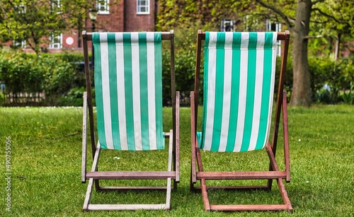 Two stripy deckchairs in the park