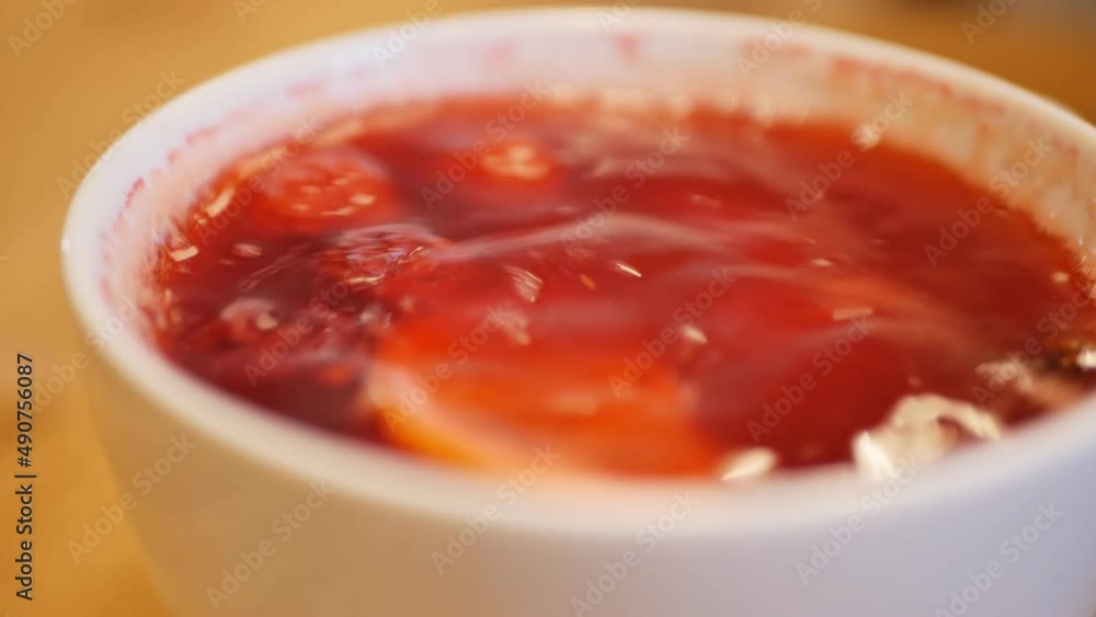 Use a spoon to stir the drink with red berries and lemon. Sweet and sour drink for good immunity Use a spoon to stir the drink with red berries and lemon. Sweet and sour drink for good immunity
