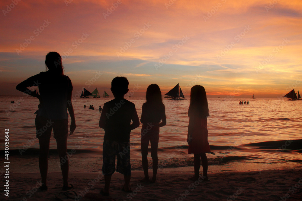 A family enjoy beautiful sunset view in Boracay, Philippines.