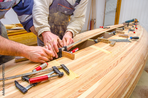 Carpenters making wooden boat in carpenter workshop. photo