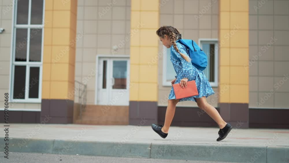 Happy girl run from school to her mother. Children education. Girl with backpack and book runs from school. Happy children and parents in the school park. Family education. Mother's Day in childcare. Happy girl run from school to her mother. Children education. Girl with backpack and book runs from school. Happy children and parents in the school park. Family education. Mother's Day in childcare.