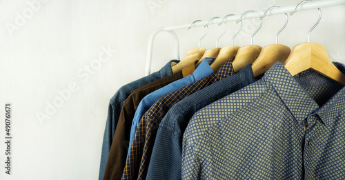 Men's clothing. Shirts hang on a hanger. Style and fashion.