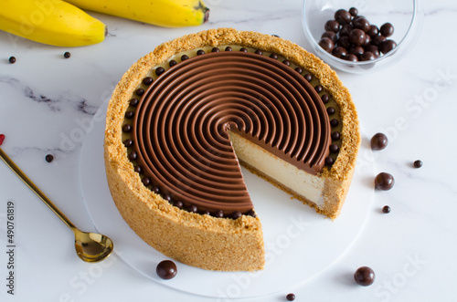banana cheesecake with chocolate on a light background