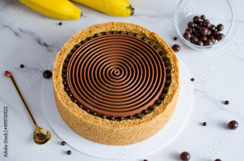 banana cheesecake with chocolate on a light background