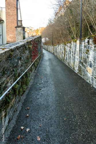 Deserted path between two stone walls