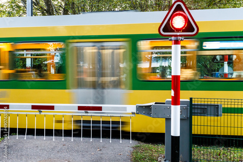 Obraz na plátně Passenger train speeding through a level crossing
