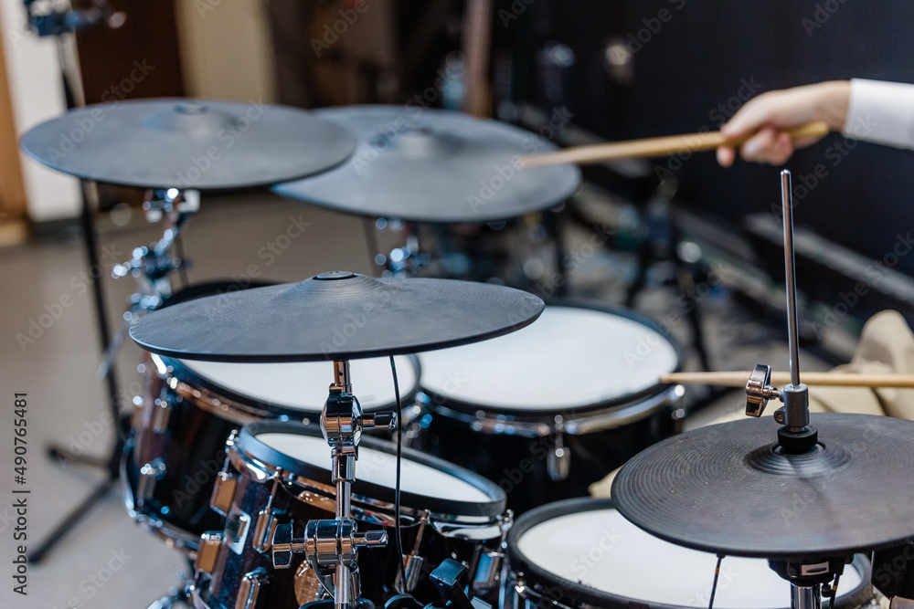Someone playing a cymbol on a set of drumsat a local church for the praise and worship team or a band Someone playing a cymbol on a set of drumsat a local church for the praise and worship team or a band