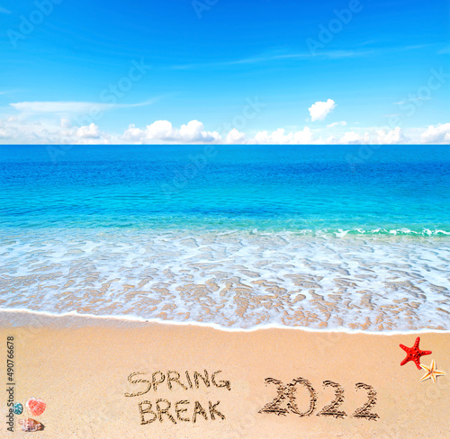spring break 2022 written on the sand