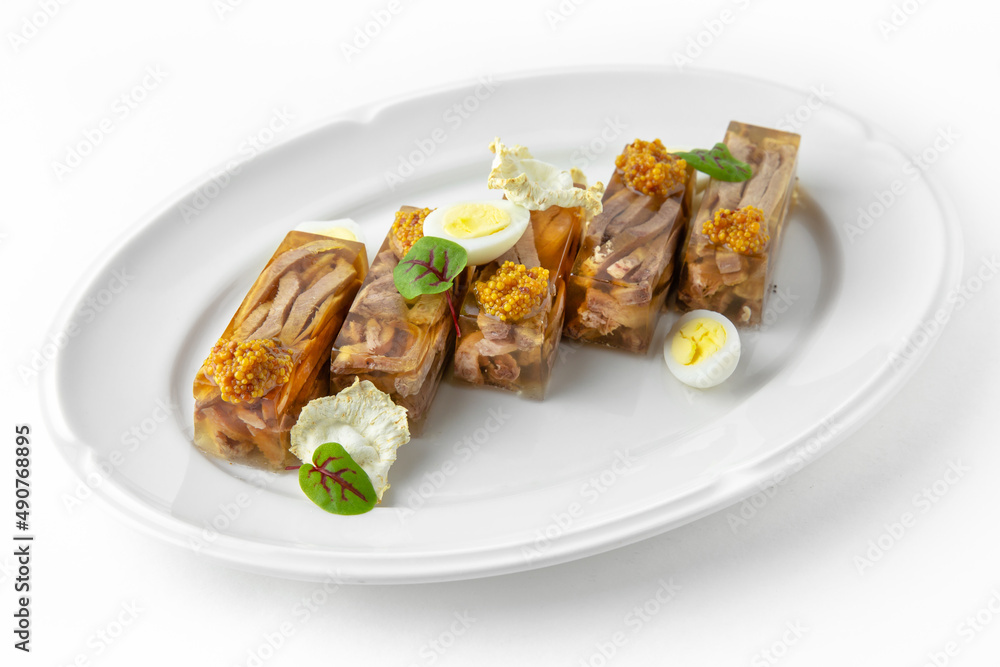 Jellied beef and pork on a white plate. Banquet festive dishes. Gourmet restaurant menu. White background. Jellied beef and pork on a white plate. Banquet festive dishes. Gourmet restaurant menu. White background.